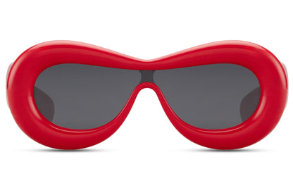 Tykke ovale hurtigbriller med ét glas og rødt stel set fra fronten